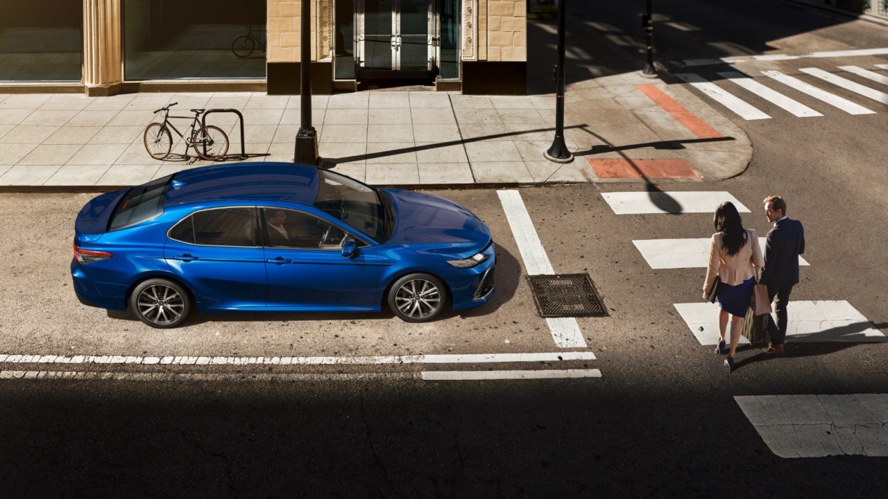 Toyota Corolla Hatchback driving down the road